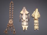 three pieces of jewelry are displayed on a gray surface