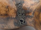 a close up of a wooden object with a black spot on it