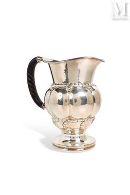 an image of a silver pitcher with a black handle on a white background