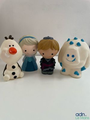four figurines of different characters sitting on a table