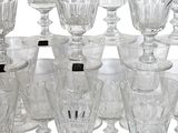 a lot of wine glasses sitting on a table