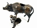bronze figurine of a bull and a man kneeling down