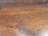 a close up of a wooden table with scratches on it