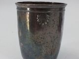 a silver cup that is sitting on a table