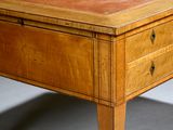 a small wooden table with a drawer on it