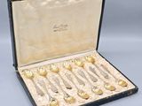 six pairs of silver spoons in a black case