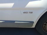 a close up of a white car with the door handle down