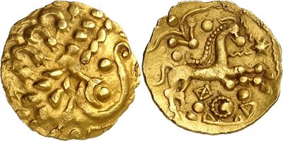 a close up of two gold coins on a white surface