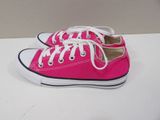 pink converse shoes with white laces are on a white surface