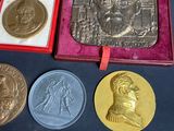 several medals are displayed in a red case on a table