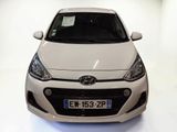 a white car that is parked in a white room