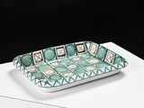 an image of a green and white tray sitting on top of a white table
