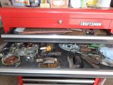 a red toolbox with tools in it in a garage