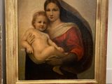 a painting of a woman holding a baby on a table