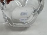 a glass vase with a red flower inside of it
