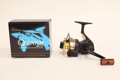 a close up of a fishing reel next to a box