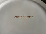a white plate with a brown writing on it