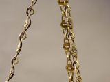 an image of a gold and blue bowl hanging from a chain