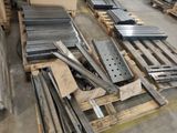 many pieces of metal on a pallet in a warehouse