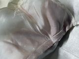 a white pillow on a bed with a white pillow cover
