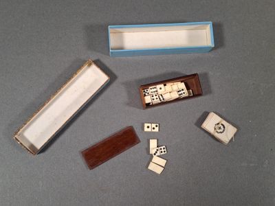 a box of dominos and a box of dices on a table
