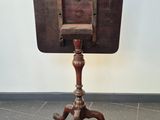 a small table with a wooden top on a tripod