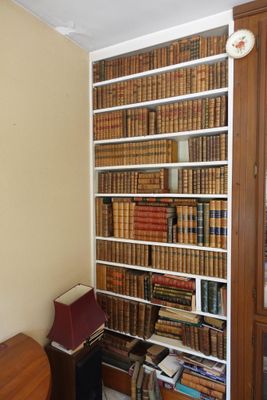 une bibliothèque remplie de livres, placée dans un coin de la pièce
