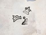 a silver plate with a picture of a cat and a dog on it