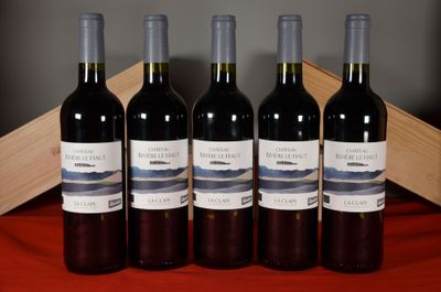 four bottles of wine are lined up on a table