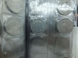 a lot of silver coins in a display case