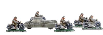 four figurines of people riding motorcycles and a car