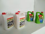 three bottles of liquid sitting on a shelf next to each other