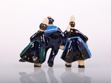 two figurines of two people dressed in blue and black