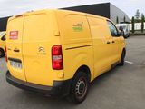 a yellow van that is parked in a parking lot