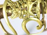 a close up of a gold plated sword with a bird on it