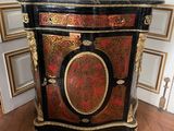 a black and gold cabinet with a red and gold decoration