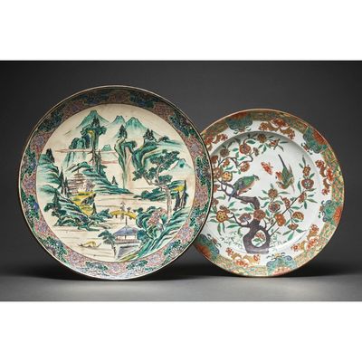 two chinese plates with birds and flowers on them on a black background
