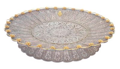 an image of a silver plate with gold decorations on it