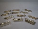a lot of silver metal clips on a white surface