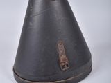 a black cone shaped object with a wooden handle on a white surface