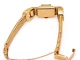 gold plated bracelet with a clasp and a chain on a white background