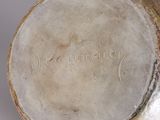 a close up of a vase with writing on it