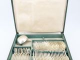a box with silverware in it on a white surface