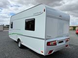 an image of a camper parked in a parking lot