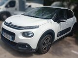 a picture of a white citrole parked in a parking lot