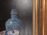 a painting of a vase and a bowl on a table