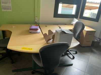 a desk with two chairs and a computer on it
