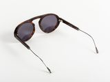 a pair of brown sunglasses on a white surface