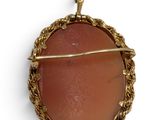 an image of a picture of a pendant with a red stone in the center