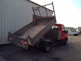 a red truck that is parked in front of a building